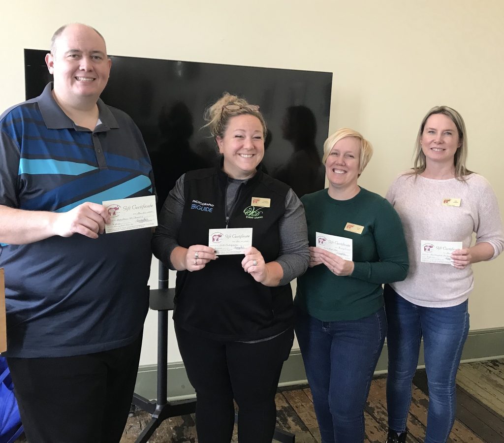 Four members of St. Thomas Executives Association smiling